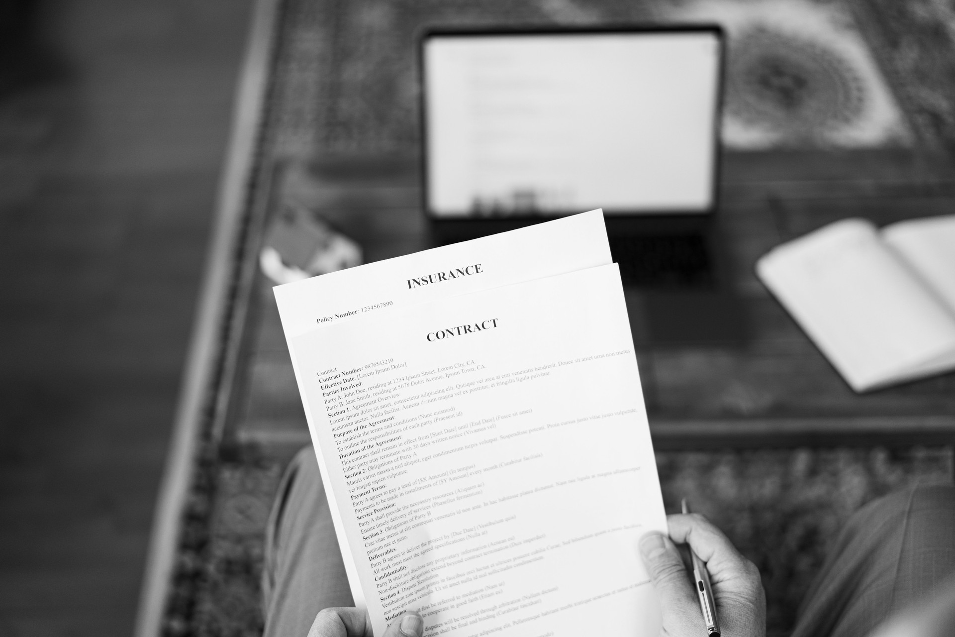 Businessman reading insurance contract at home office